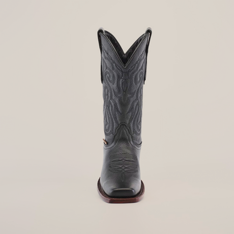 Front view of the Grisly Black - Rodeo Toe cowboy boot, highlighting detailed embroidery on its shaft against a white backdrop. Made from premium cowhide leather, it boasts a pointed toe and dark brown sole.