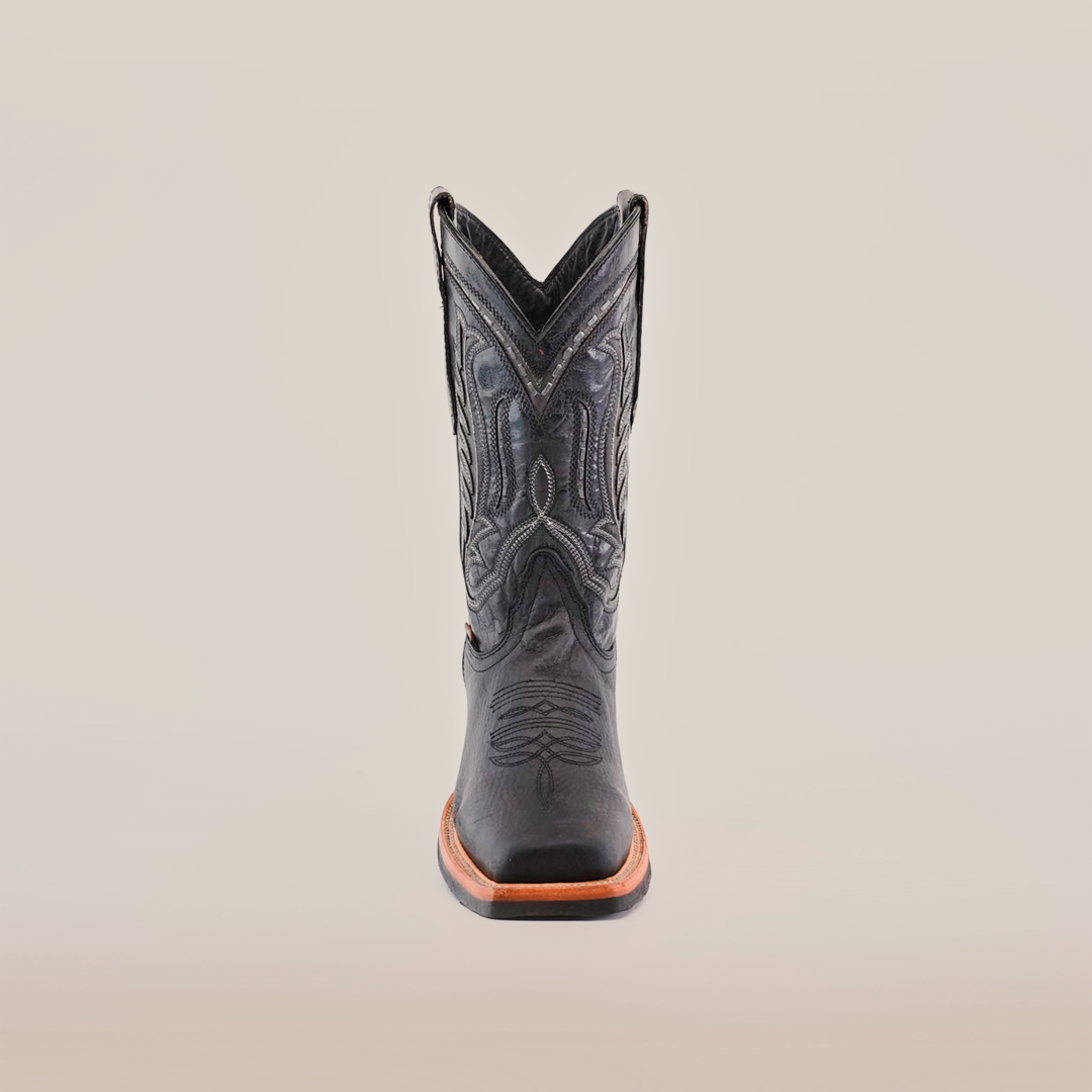 The Cheyenne Black boot with a Rodeo Toe, made from premium cowhide leather, showcases intricate front stitching on a white background. It features a brown slip-resistant sole for style and practicality.