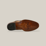 The bottom view of the Exotic Full Quilt Ostrich - Orix - Round Toe shoe shows a leather sole with visible stitching and nails exuding cowboy style. The black heel includes textured detailing, and the Yee-Haw branding with a star motif near the heel enhances its resemblance to ostrich leather boots.