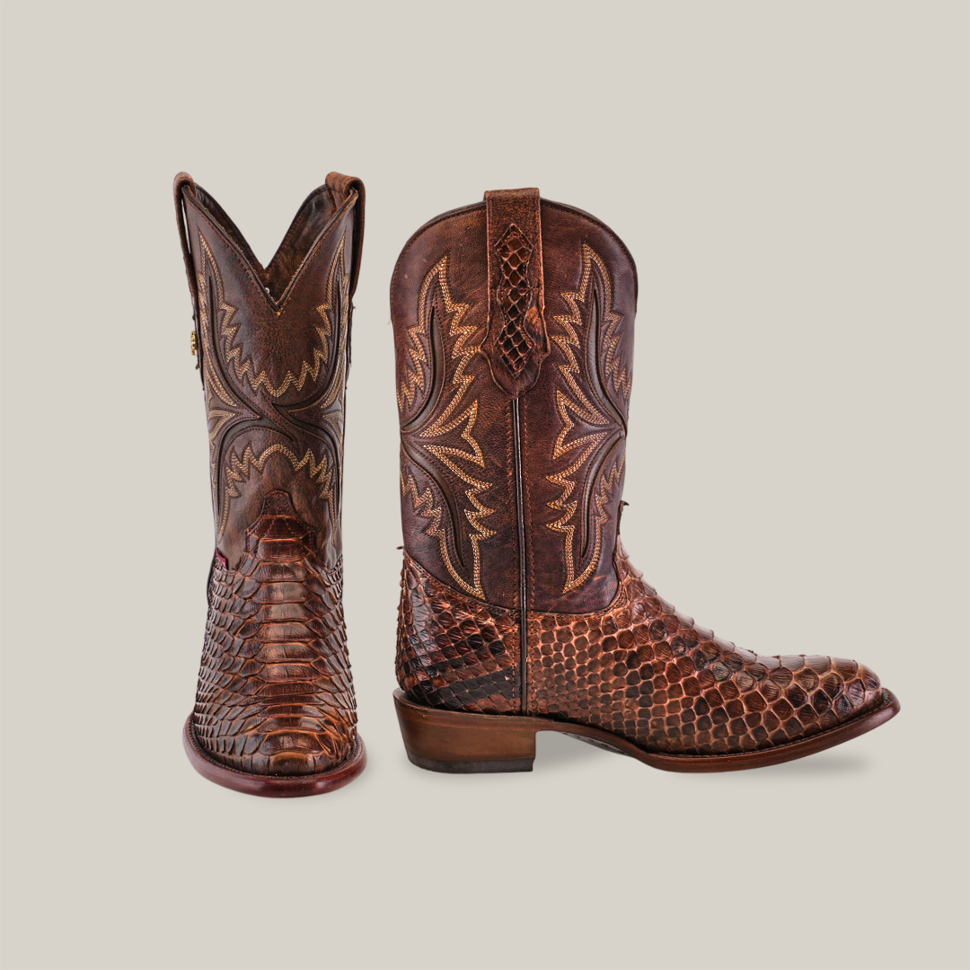 The Exotic Python - Brown - Round Toe boots boast intricate stitching and textured patterns. The left boot is displayed front-on, while the right boot is shown from the side against a beige background, exemplifying Western footwear elegance.