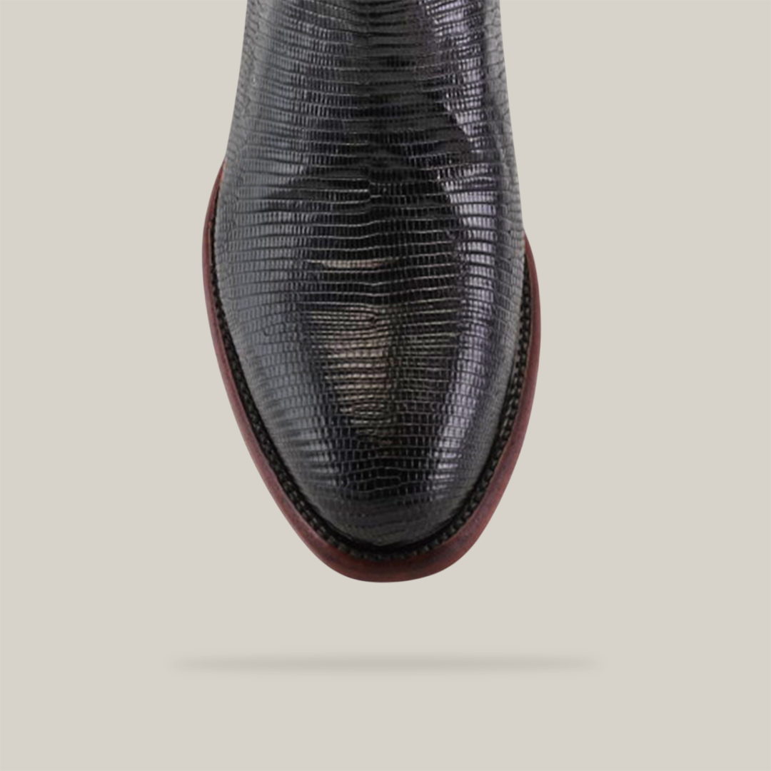 Close-up of the Exotic Lizard - Black with round toe, crafted from genuine lizard leather featuring a textured scale pattern, set against a neutral gray background. The shoe has a reddish-brown sole.