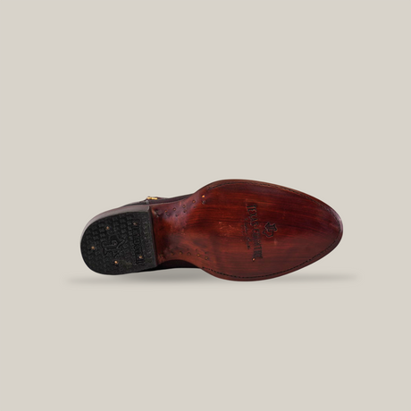 The image features the sole of the Exotic Stingray - Wine - Square Toe shoe, showcasing luxury craftsmanship against a plain background. Nail details are evident, with a rubber heel and embossed branding near the arch.