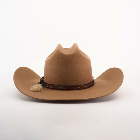 The 6X Doble SS Fawn, a sheeps wool cowboy hat in brown, features a wide brim and decorative leather band with a small tassel, set against a plain white background.