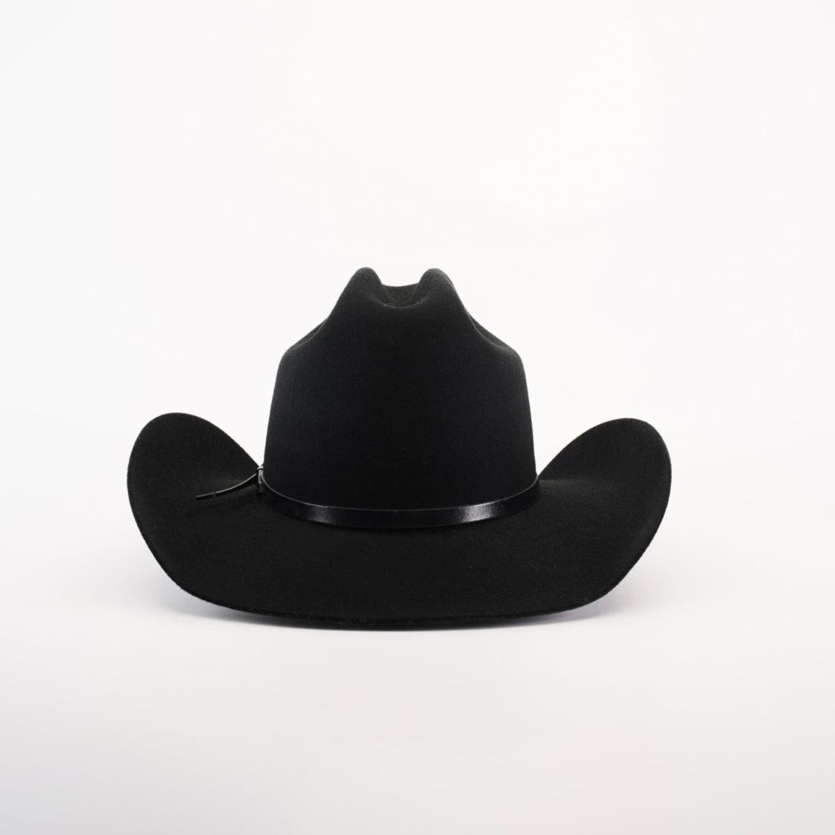 The 6X Leandro Black is a luxurious cowboy hat crafted from sheeps wool, featuring a wide brim and slightly curved shape. It rests elegantly on a plain white background, adorned with a thin black band around the crown.