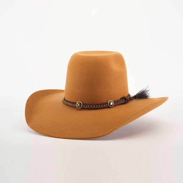 The 6X Brazil Fawn is a wide-brimmed, brown cowboy hat made from Brazil felt. It features a premium leather band with star-shaped ornaments and a feather, all against a plain white background, highlighting its stylish design.