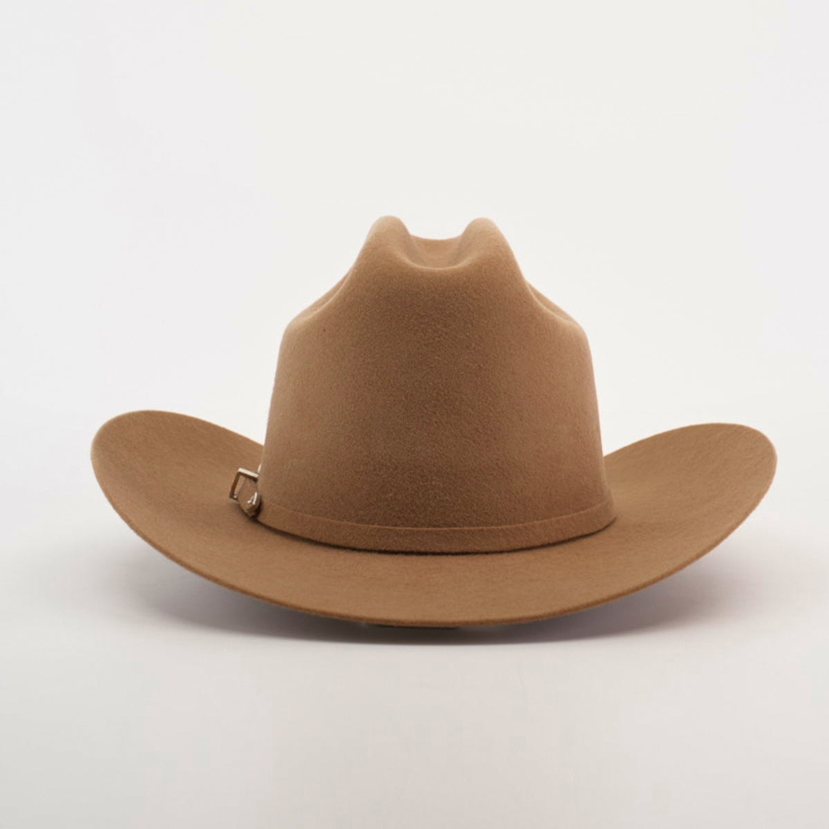 The 6X 2 Carnales Fawn, a tan cowboy hat crafted from sheep wool with a wide brim and pinched crown, rests elegantly on a neutral background.