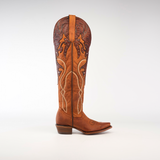 The Miriam Brick - Tall Shaft - Snip Toe is a womens tall, brown leather cowboy boot crafted from premium materials with intricate decorative stitching and a detailed embossed pattern at the top. It features a low heel and slightly pointed toe, displayed on a plain white background.