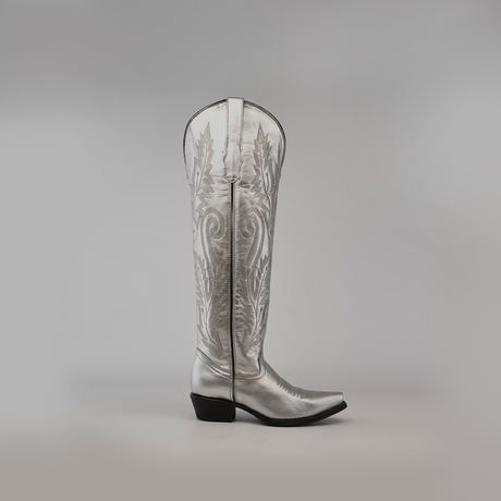 The Brittany Silver-Tall Shaft-Snip Toe Boot combines premium leather with western-style embroidery in its handcrafted design. This silver boot features a snip toe, low heel, side zipper closure, and stands out elegantly against a plain, light background.