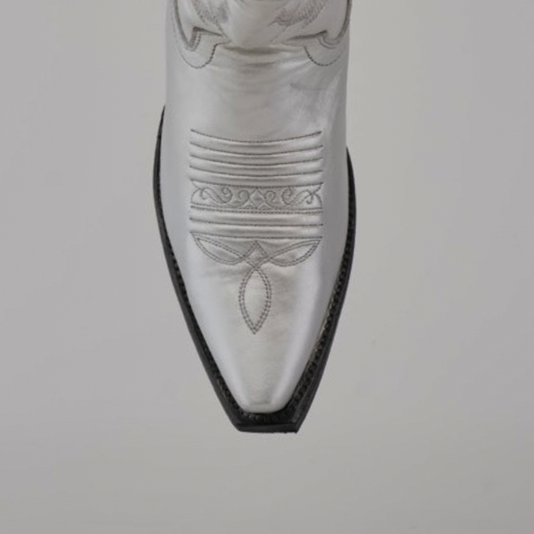 Close-up of the pointed toe on a Brittany Silver–Tall Shaft–Snip Toe Boot, highlighting intricate stitching on premium leather against a plain gray background.