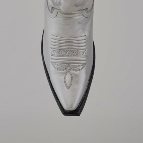 Close-up of the pointed toe on a Brittany Silver–Tall Shaft–Snip Toe Boot, highlighting intricate stitching on premium leather against a plain gray background.