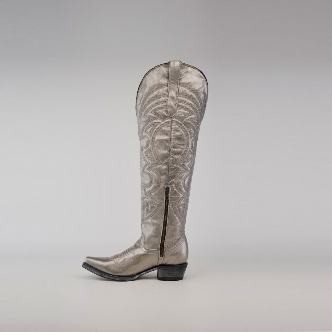 The Taylor Mercury - Tall Shaft - Snip Toe boot, a single silver cowboy boot, stands upright against a plain background. Designed by Taylor Mercury, it has intricate patterns, a low heel, and a durable leather sole.