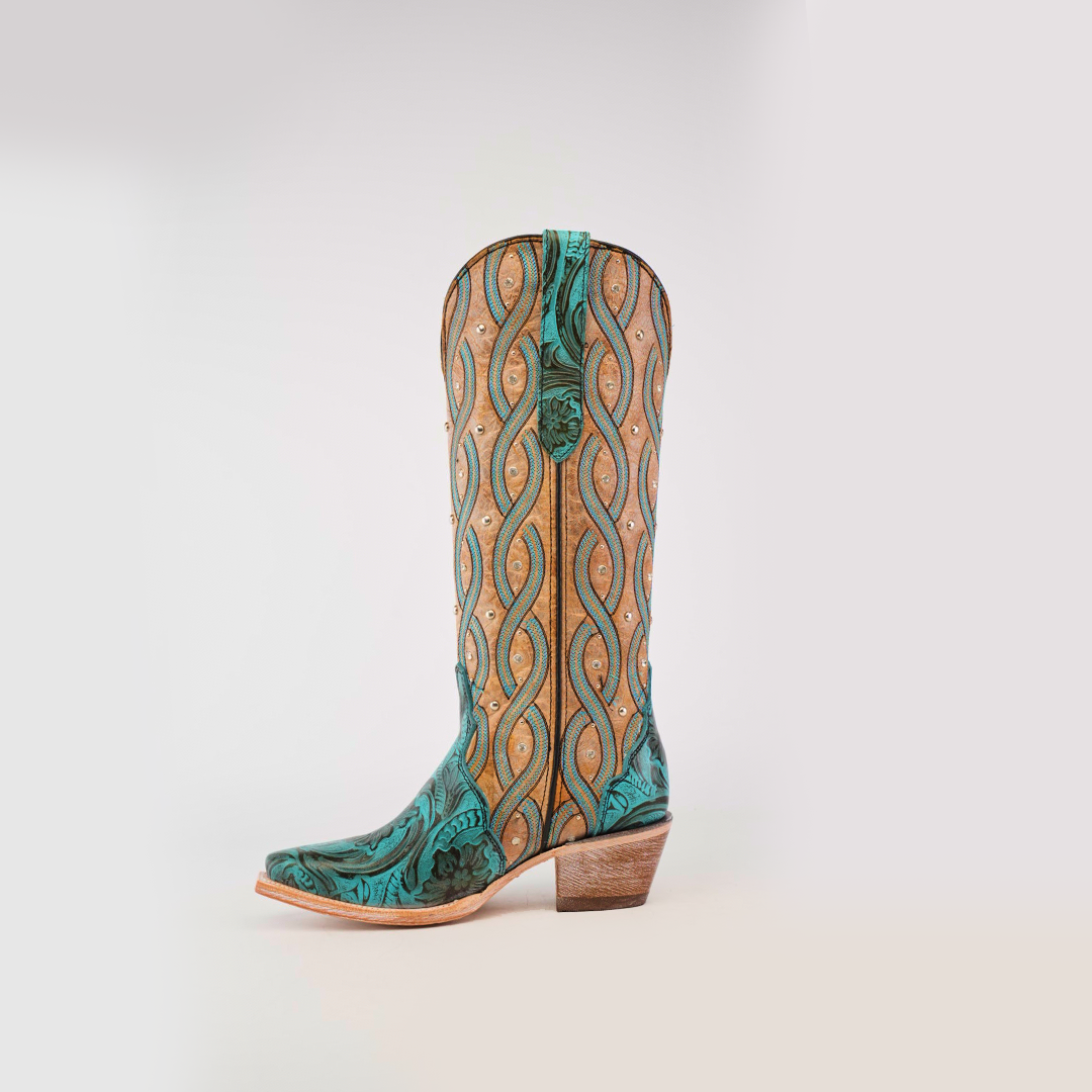 Against a plain white background, the Premier Turquoise Handtooled Flowers cowboy boot stands upright, featuring a tall shaft and snip toe. Crafted from premium leather, it showcases intricate teal and tan swirling patterns reminiscent of turquoise handtooled flowers.