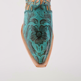 The photo features the Premier Turquoise Handtooled Flowers boot, showcasing premium leather with ornate green and black floral patterns. It has a snip toe design, intricate seam stitching, and elegant turquoise hand-tooled flowers against a plain white background.