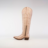 A single tall beige cowboy boot with decorative stitching and a side zipper is showcased against a white backdrop, echoing the iconic Sara Metalic Florentine - Tall Shaft - Snip Toe design.