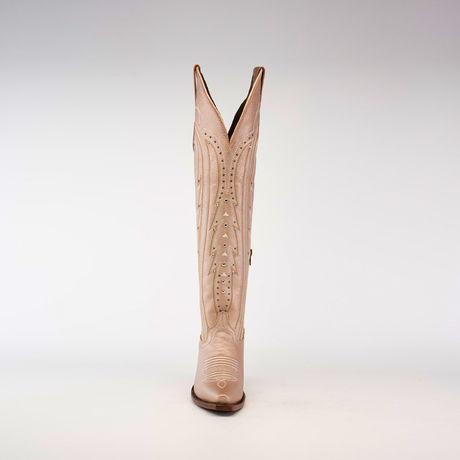 A single pink cowboy boot stands upright on a white background, featuring decorative stitching and cutouts. Its snip toe and raised heel echo the elegance of the Sara Metallic Florentine - Tall Shaft, while the V-shaped opening adds a unique touch.