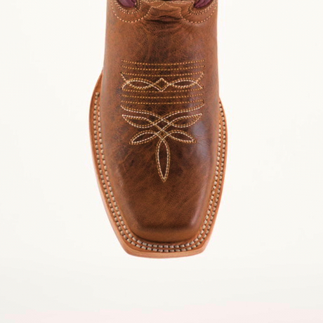 The Grecas Orix - Square Toe is displayed from the top view, showcasing its premium brown leather, intricate embroidery, square toe, and visible stitching along the soles edge. Its a fashionable choice for girls boot style enthusiasts on a plain white background.