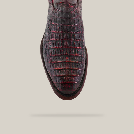 A top-down view of the Exotic Caiman Hornback shoe, Black Cherry, Round Toe, showcases its glossy finish and textured details against a plain beige background.