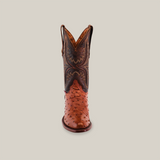 Front view of a single Exotic Full Quilt Ostrich cowboy boot in Brandy, featuring intricate stitching on the brown upper and a textured reddish lower, highlighting handcrafted artistry against a plain background.