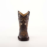 The Dariela Chocolate - Square Toe is a premium leather cowboy boot in dark brown, featuring intricate floral embroidery and stitching. This elegant piece is displayed front-facing against a plain white backdrop.