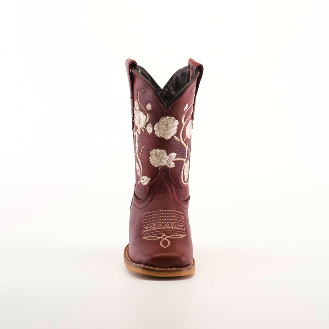 Front view of a single handcrafted leather cowboy boot, akin to the Jatziry Cogñac - Square Toe style, showcasing intricate white floral embroidery on its maroon surface. It features a tan sole and dark interior, set against a white background.