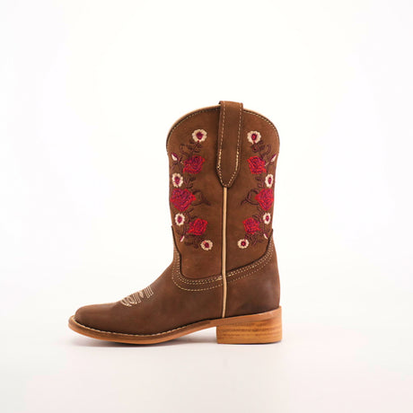 The Mia Copper Suede - Square Toe cowboy boot showcases premium leather craftsmanship with red and white floral embroidery on the shaft, complemented by a wooden heel and a rounded toe against a plain white background.