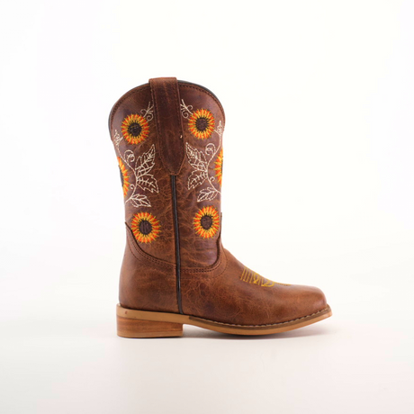 The Sunflowers Tabaco - Square Toe boot highlights top-notch craftsmanship with sunflower and leaf embroidery on premium leather. This single brown boot, displayed on a plain white background, features a durable wooden heel.