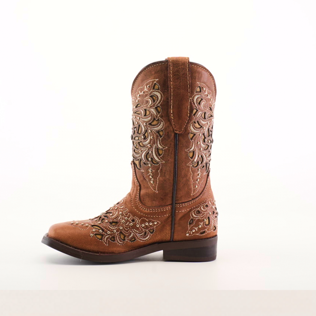 A single Kiara Studs Fawn boot, crafted from premium leather with floral embroidery and decorative stitching, is displayed against a white background. Featuring a low heel and slightly pointed square toe, this stylish brown cowboy boot is perfect for fashion-forward young girls.