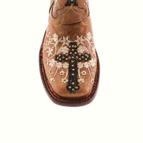 The Margacruz Studs Orix - Square Toe is a brown girls boot made from premium leather, adorned with a decorative cross and floral embroidery featuring white flowers and intricate stitching for a detailed, elegant look.