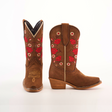 The Mia Copper Suede Snip Toe boots are brown, featuring red rose embroidery and snake designs. Handcrafted from premium leather, they have wooden heels and intricate stitching. One boot stands upright; the other lies flat to highlight detailing.