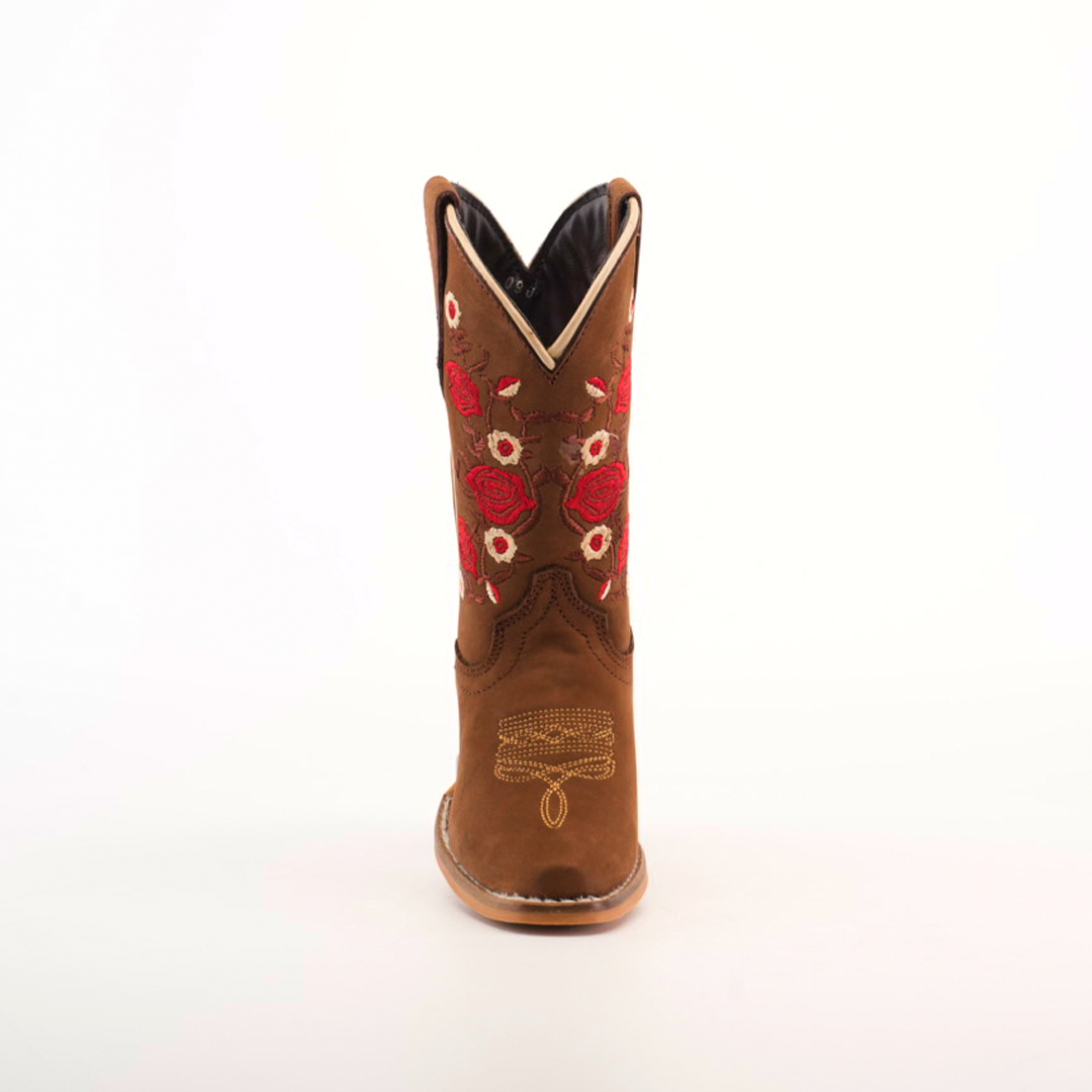 The Mia Copper Suede - Snip Toe boots feature premium leather in a brown cowboy design, complemented by red and white floral embroidery on the shaft. Ankle stitching enhances the look, and a light-colored sole completes the design against a plain white backdrop.