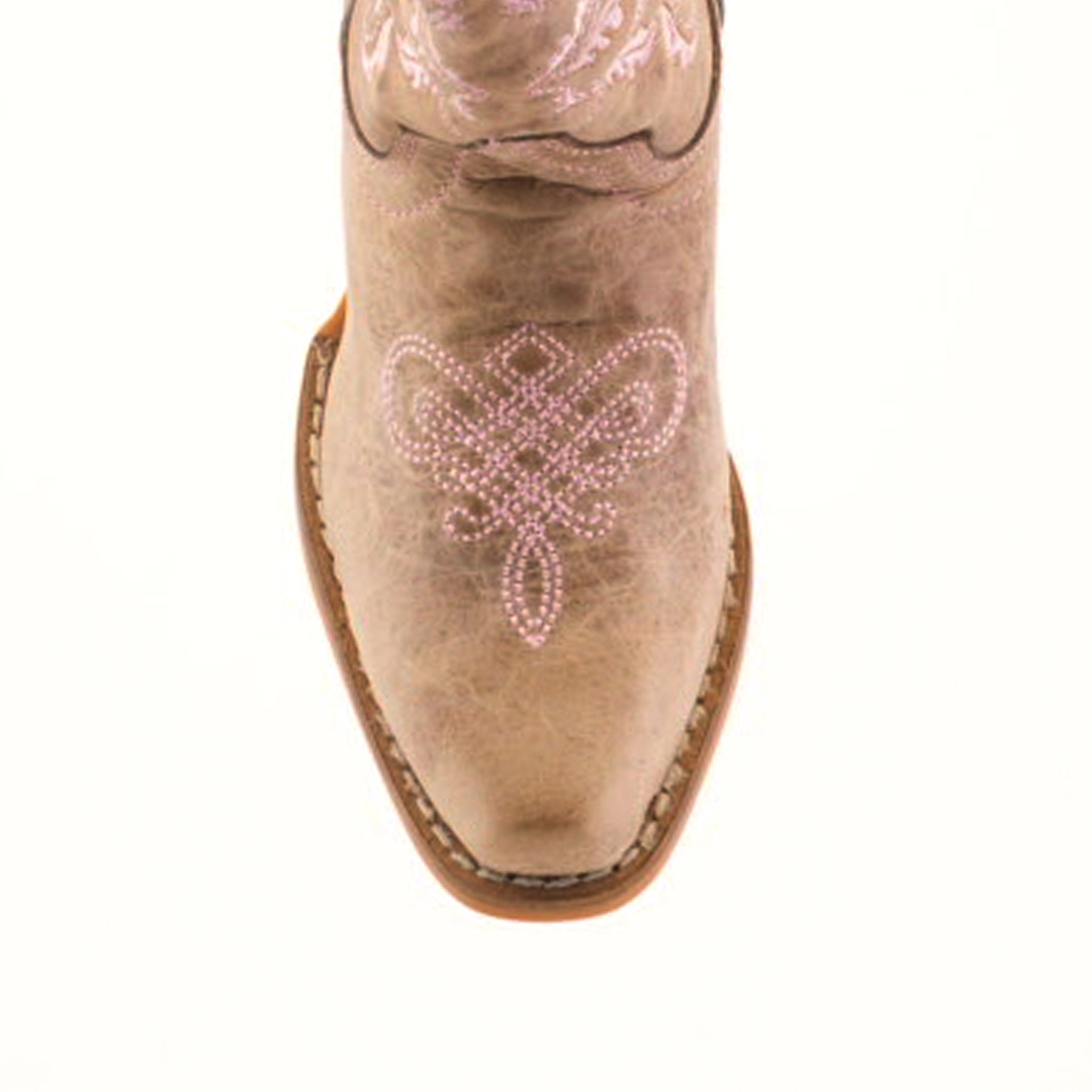 A top view of the Bellere Fawn - Snip Toe boot highlights its premium cowhide leather, intricate pink embroidery on the toe, and light brown sole. The symmetrical floral or scroll design stands elegantly against a plain white backdrop.