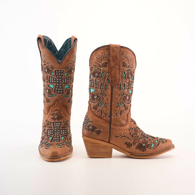 The Alamo Studs Honey -+ Snip Toe boots are girls cowboy boots crafted from brown cowhide leather, featuring intricate floral and cross-shaped embroidery with turquoise stone accents. They have a moderate heel, decorative stitching, and are shown side by side on a white background.