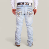 Someone is wearing Western Blue Straight Fit Embroidered Jeans (WJ2343) featuring decorative stitching on the back pockets, accented with a patterned belt and brown shoes. The individual in a long-sleeve white shirt is facing away.