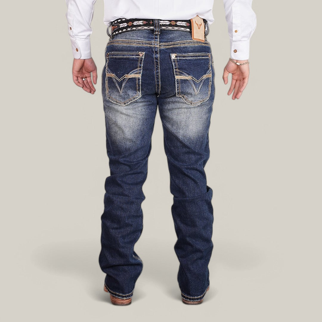 A person in a white shirt and Western Blue Straight Fit Embroidered Jeans - W433, showing decorative stitching on the back pockets, stands with their back to the camera. They wear a patterned belt and brown shoes against a plain backdrop.