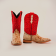 A pair of Cowhide Hair Red Suede Shaft Pinto - Square Toe cowboy boots with red suede shafts, speckled tan and brown cowhide leather feet, a wooden heel, and leather soles; one boot stands upright while the other is slightly angled to display its side.