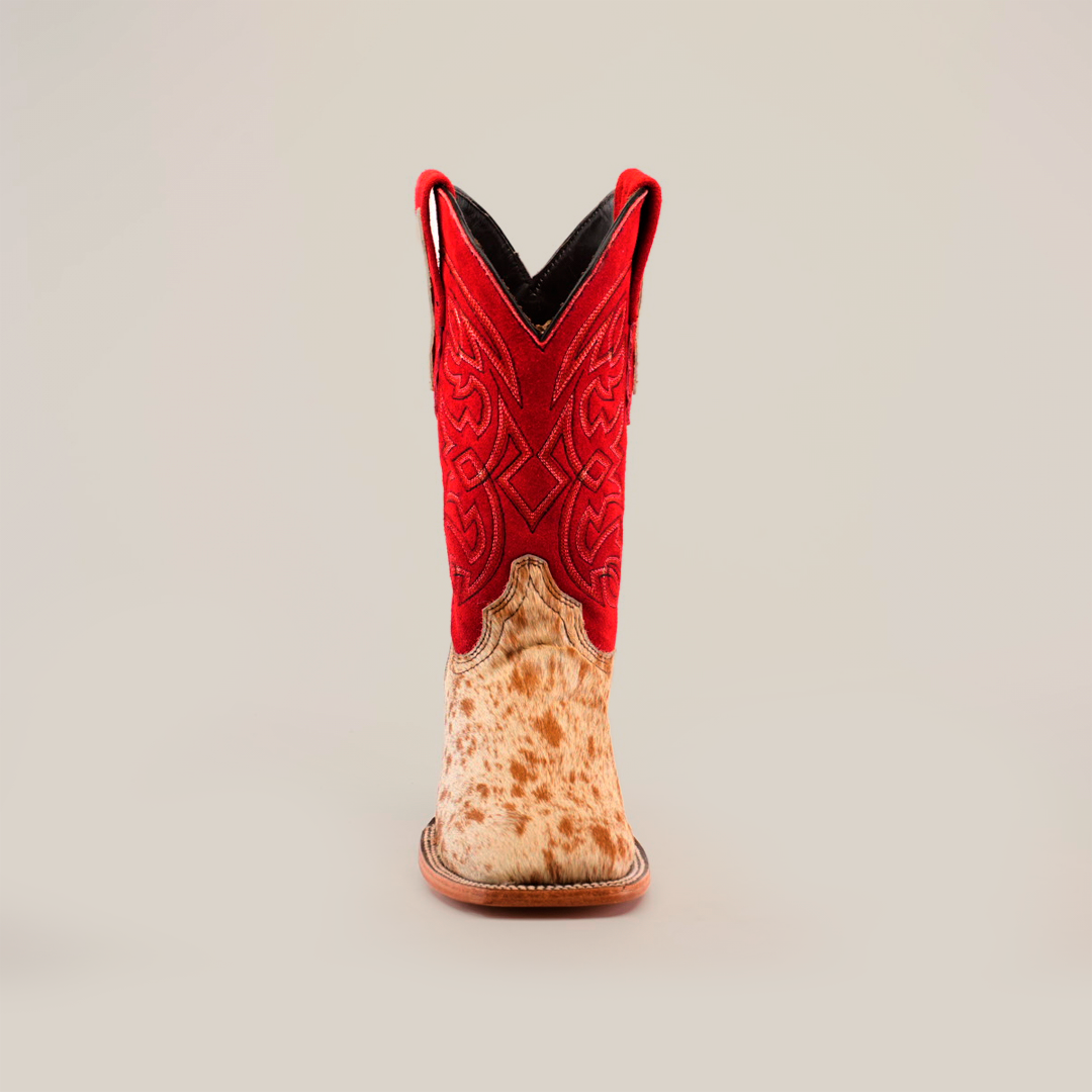 A single cowboy boot from the Cowhide Hair Red Suede Shaft Pinto collection, showcasing a red suede shaft with intricate patterns and brown pull straps. The cowhide leather lower section has brown speckles and a square toe design, resting on a classic brown sole against a white background.