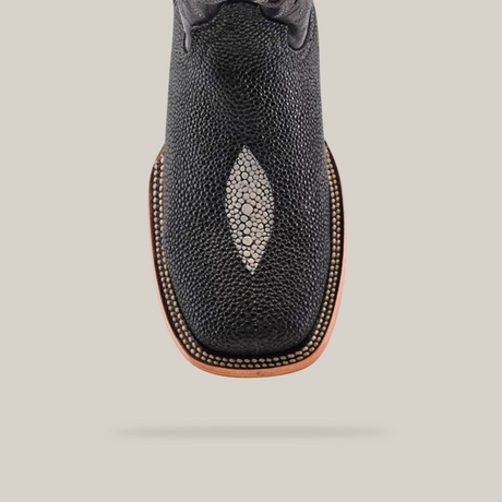 Close-up of the King Stingray Print Black - Square Toe boot, handcrafted in premium cowhide leather, showcasing a textured surface with a diamond-shaped lighter inlay on the toe and decorative stitching around the square toe design.