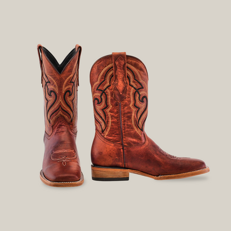 The Fresno Shedron - Square Toe cowboy boots, crafted from premium cowhide leather with intricate stitching, feature one boot upright to reveal front and side details, while the other highlights a side view against a white background, embodying classic style.