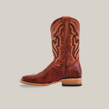 The Fresno Shedron - Square Toe is a brown western cowboy boot with intricate embroidery along the shaft, crafted from premium cowhide leather. It features a square toe, leather heel, and side pull straps, all presented on a plain white background emphasizing its craftsmanship.