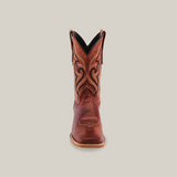 A single brown leather cowboy boot, Fresno Shedron in color, crafted from premium cowhide with intricate black and tan stitching stands upright against a white background. It features a textured sole and square toe design.