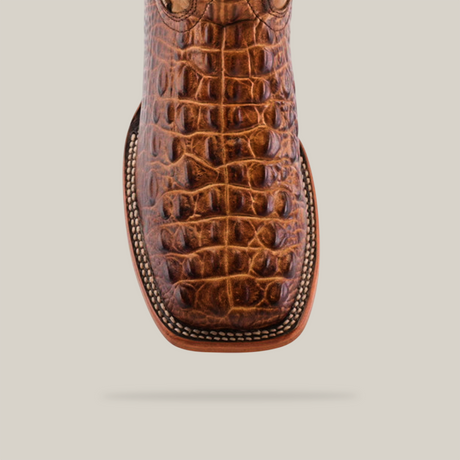 A close-up of the Morelet Crocodile Print Orix - Square Toe boot highlights its rich brown crocodile print and intricate edge stitching against a plain white background.