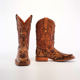 A pair of Handtooled Leave Orix cowboy boots with detailed engravings, made from premium cowhide leather. The left boot stands upright while the right reveals its slip-resistant sole on a plain white background.