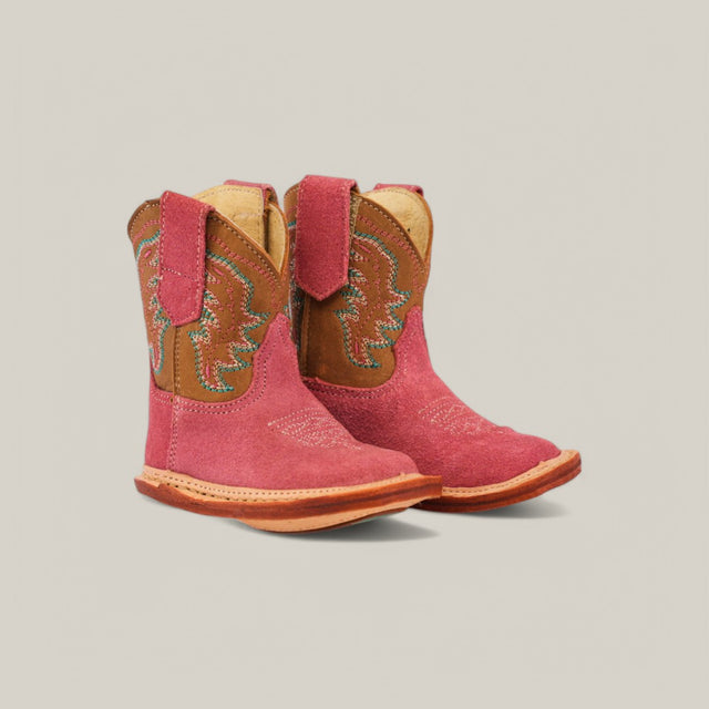 The Harper childrens cowboy boots in pink suede with a camel shaft feature decorative stitching, square toes, and handy pull tabs, all set against a plain light background.