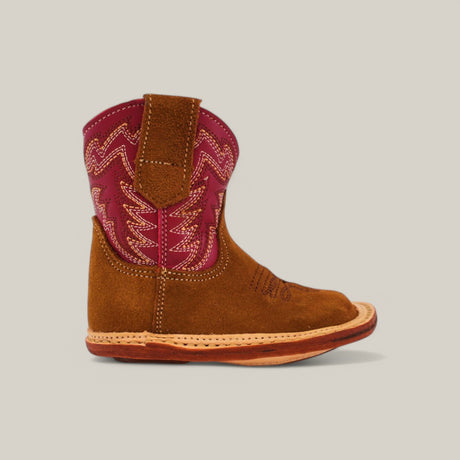 The Sommer Camel Red Shaft boot for kids, with its vibrant red upper featuring decorative stitching, premium materials, and light brown sole for contrast, showcases a small cowboy design with a rounded toe on a neutral background.