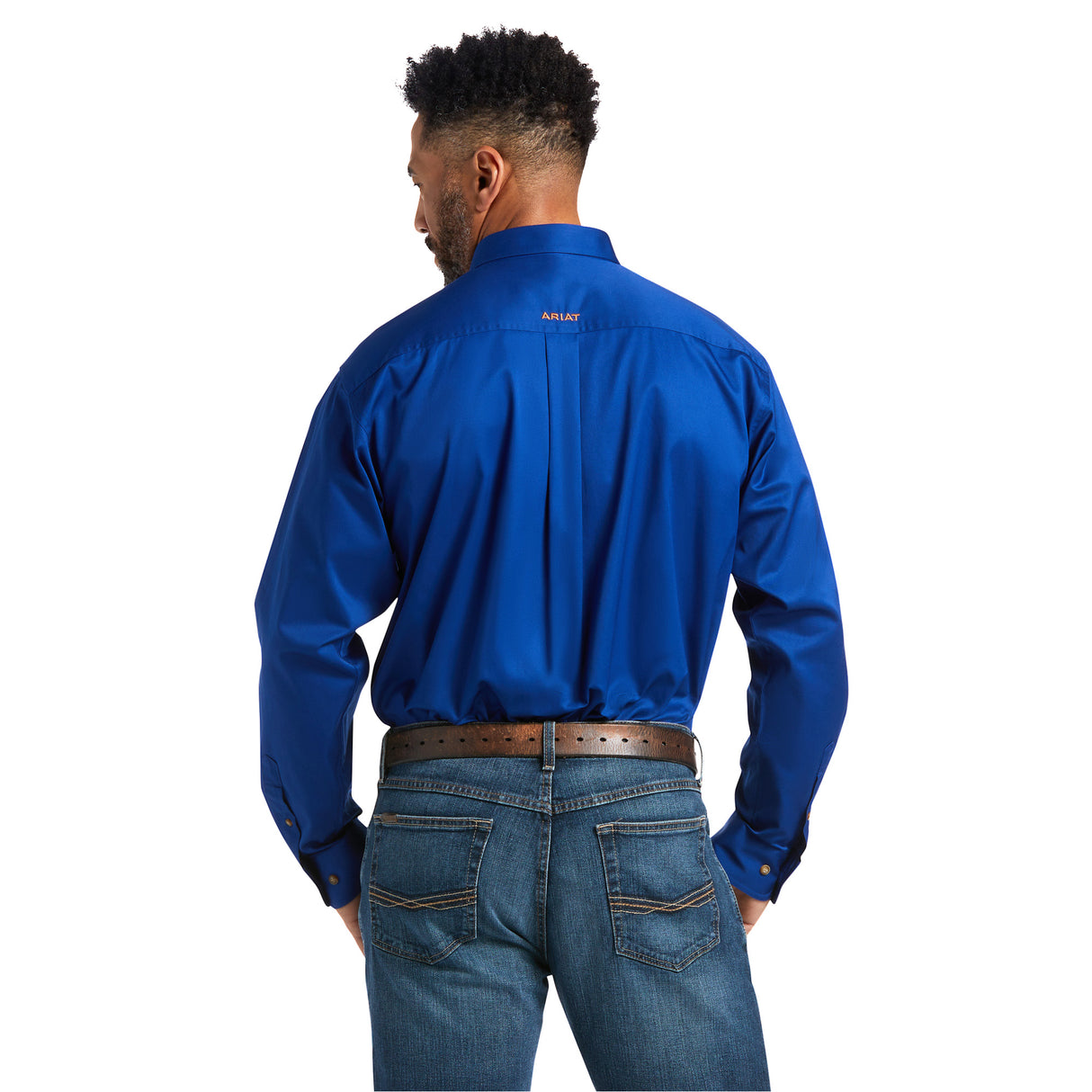 A man with short black hair wears a Solid Twill Classic Fit Shirt Blue (10006660) made of 100% cotton, paired with blue jeans and a brown belt. Facing away, he showcases the back of his classic outfit.