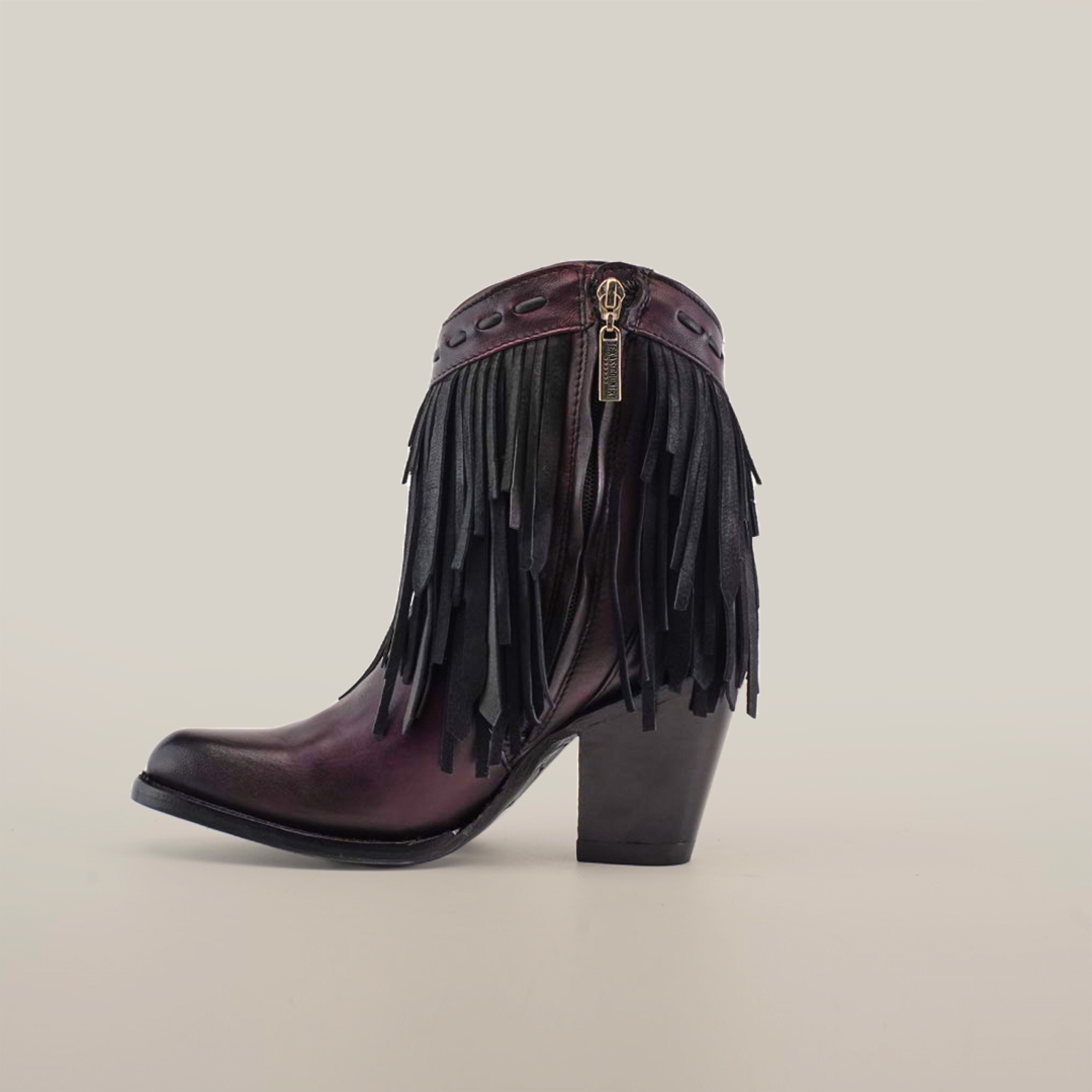 Introducing the Austin Fringe Bootie Wine - J Toe, part of our Platinum Collection. This chic ankle boot is crafted from premium leather and features a block heel, decorative black fringe, and a side zipper against a plain white background.