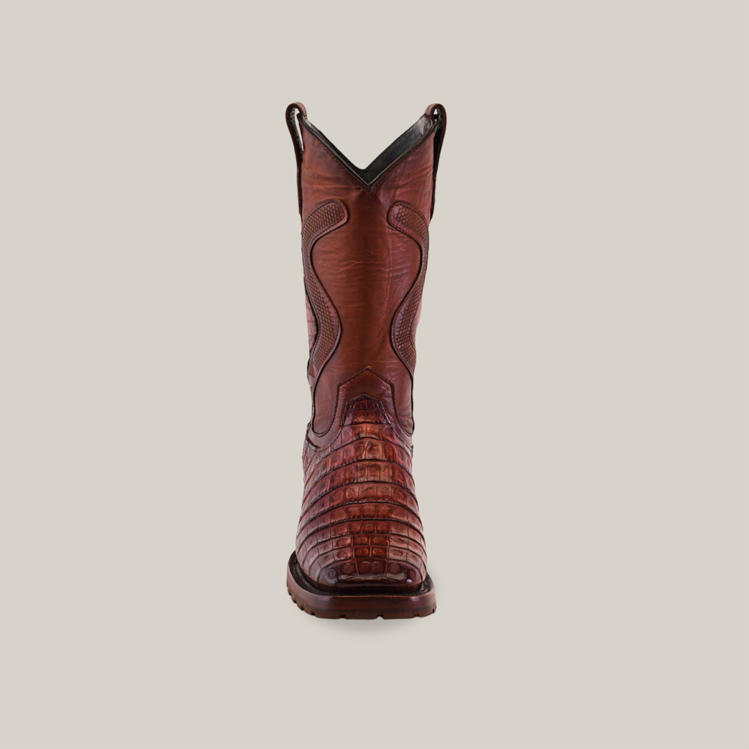 The Exotic Caiman Belly Tail - Diamond features a Brandy color with a textured, crocodile-like pattern on the toe and intricate stitching on the shaft for Western flair. Its Goodyear Welt construction ensures durability, showcased upright against a white background, ready for its next adventure.