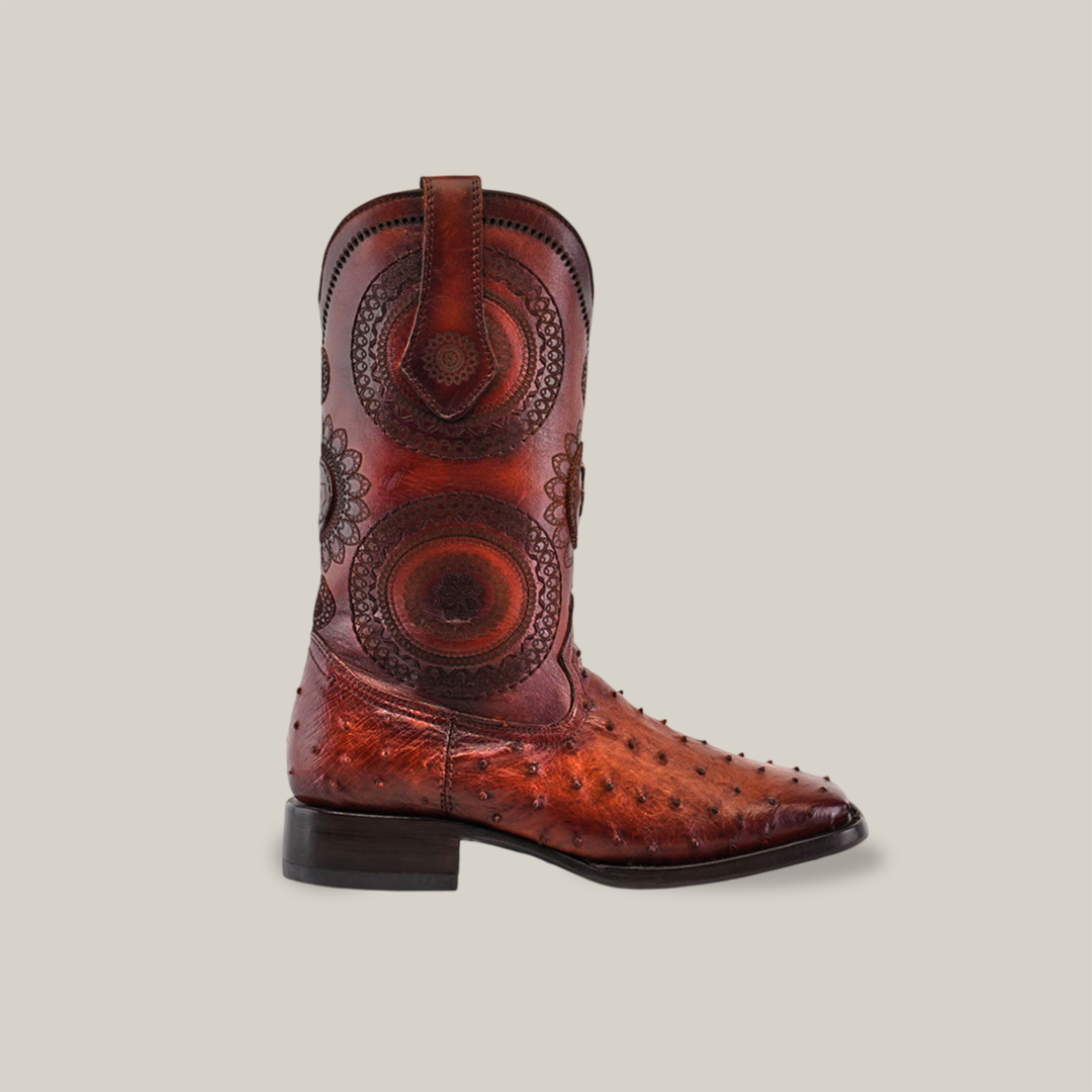 From the exclusive Platinum Collection, the Exotic Karoo Ostrich - Platinum - Honey features intricate circular patterns on the shaft, a smooth square toe with subtle stud detailing, and a dark wooden heel. Embrace cowboy culture with two side pull straps for easy wear.