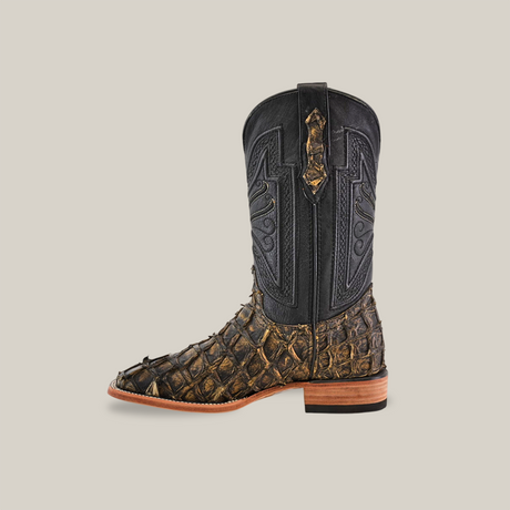 Displayed is a single Exotic Piraruco Fish rustic antique boot. It has a textured, dark brown lower resembling reptilian scales, akin to Piraruco fish boots, with a smooth black upper featuring decorative stitching and a light brown wooden sole and heel.