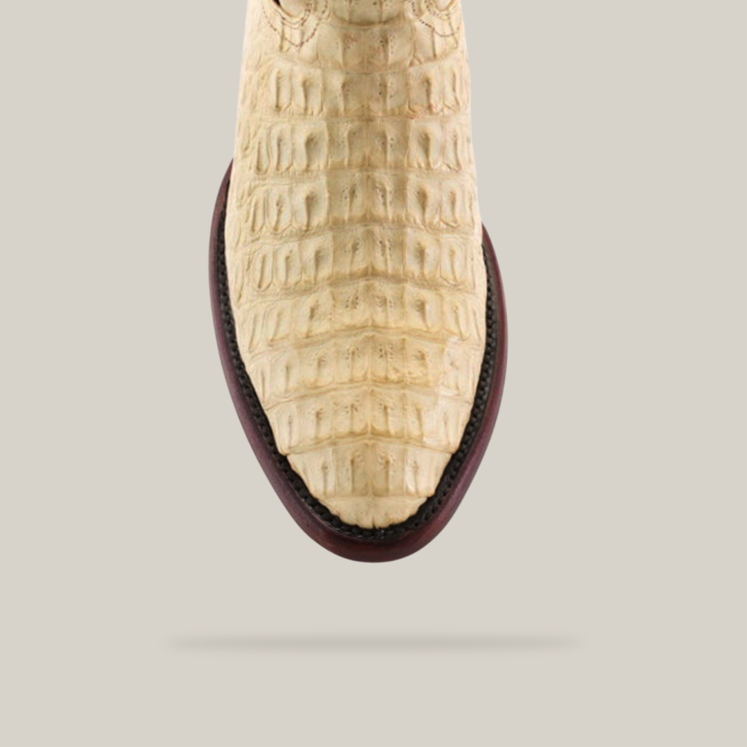 Top view of the Exotic Caiman Hornback - Bone - Round Toe boot, showcasing its beige crocodile skin pattern reminiscent of caiman leather on a neutral background, with darker trim along the sole emphasizing intricate texture.